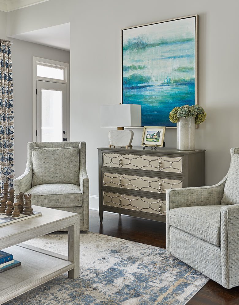 Interior of a living room featuring two chairs and a coffee table.